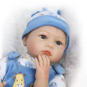 Close-up of lifelike baby doll with blue eyes and cartoon giraffe printed outfit