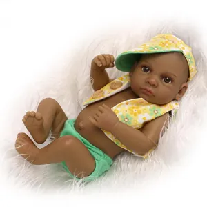 Detail view of dark skin reborn baby doll with floral outfit on soft white plush rug