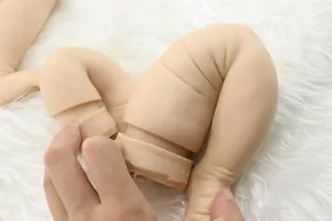 Detail shot of soft silicone reborn doll limbs with realistic skin texture on faux fur