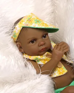 Detailed close-up of dark skin baby doll wearing a floral hat and yellow vest on plush rug