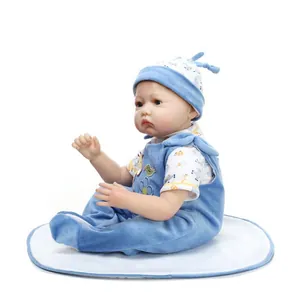 Detailed close-up of realistic newborn baby doll in blue velvet overalls and giraffe shirt