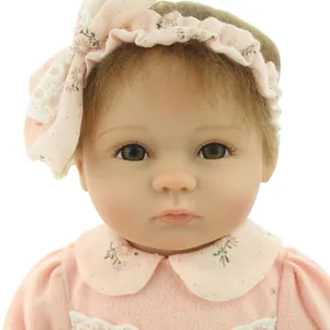 Realistic reborn baby doll for girls with pink floral headband and knit sweater