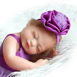 Close-up of baby headband with a large purple satin flower and white lace center detail