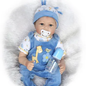 Close-up of lifelike reborn baby doll in blue giraffe outfit with bottle and pacifier