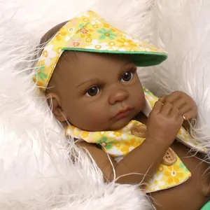 Deep skin tone reborn baby doll in yellow floral sun hat and matching vest outfit