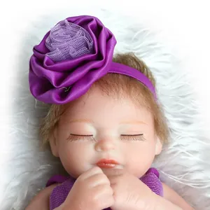 Close-up of deep purple baby headband featuring a large satin rose and soft mesh center