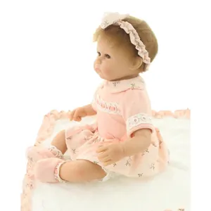 Realistic reborn baby doll in pink floral dress with matching headband and soft shoes