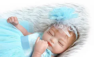 Close-up of realistic blue dress reborn doll with floral headband on plush rug