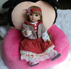 Close-up of doll with blue eyes and polka dot dress sitting on a plush cushion