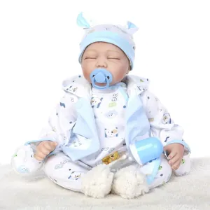 Lifelike soft silicone reborn baby doll with blue outfit, pacifier, and bottle on white fur