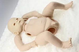Unpainted reborn doll kit including head, male torso, and limbs on white plush background