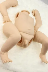 Detailed full vinyl parts of a realistic reborn boy doll kit on white plush background