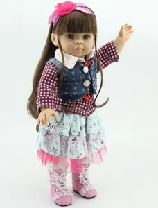Detailed view of fashion doll with brown hair, floral headband, and stylish denim vest