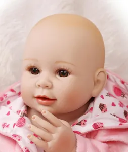 Close-up of silicone baby doll with realistic eyelashes and pink dessert print hoodie
