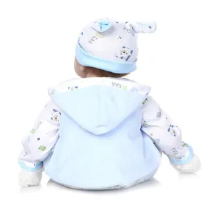 Detail view of the soft plush bear pattern fabric on the back of the reborn baby doll outfit