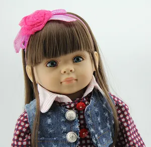 Close-up of lifelike doll featuring pink floral headband and blue denim vest detail