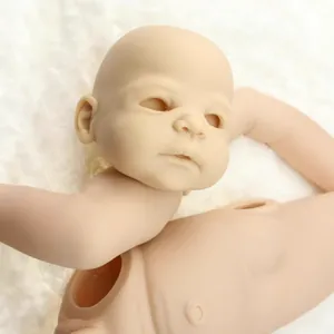 Unpainted vinyl reborn baby doll kit with head and torso on white plush background