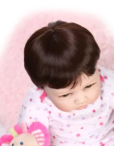 Close-up of realistic dark brown short hair and floral outfit on a reborn baby doll
