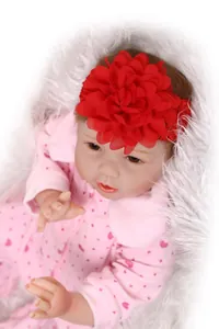 Close-up of baby headband with a large red chiffon flower on a soft knit band