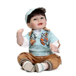 Realistic reborn boy doll with blue eyes and brown hair in blue polo and khaki pants