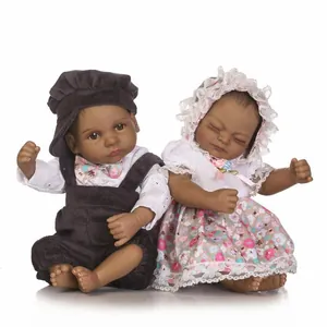 Realistic black vinyl newborn twin dolls in detailed corduroy and lace outfits