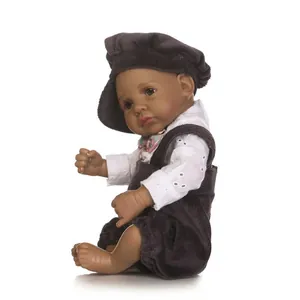 Detailed close-up of a realistic African-style baby doll wearing a white lace top and corduroy set