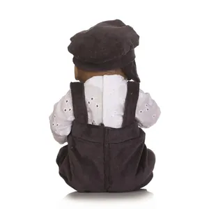 Detail view of mini reborn doll back wearing brown corduroy beret and matching overalls