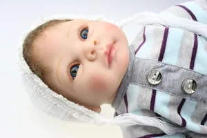 Close-up of lifelike reborn baby doll face featuring realistic eyelashes and blue eyes