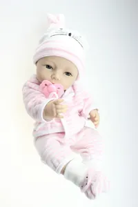 Detailed close-up of a lifelike baby doll with pink striped outfit and heart pacifier