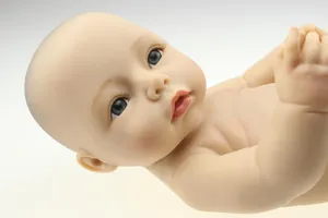 Close-up of realistic newborn baby doll showing detailed facial features and skin texture