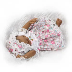 Detail of reborn baby doll in floral lace dress lying on white faux fur carpet