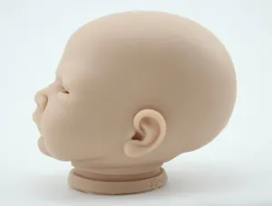 Detail view of skin-tone silicone reborn doll head model with closed eyes and YS-061 mark