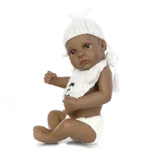 Detailed close-up of dark-skinned reborn baby doll with white knitted panda outfit