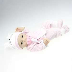 Realistic reborn baby doll in pink striped outfit with pacifier on a white background