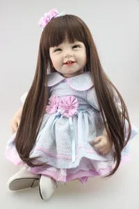Close-up of realistic reborn doll with long brown hair, floral headband and lace dress