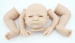 Macro shot of unpainted soft silicone reborn doll parts kit with closed eyes head and limbs