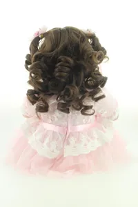 Rear view of 20-inch doll with long brown wavy hair and pink lace princess dress