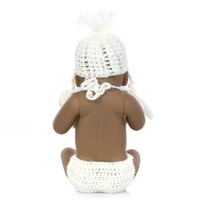 Macro view of dark skin baby doll back with realistic skin folds and white knit outfit