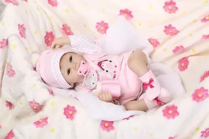 Lifelike reborn baby doll in pink floral onesie with magnetic pacifier and bottle