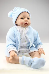 Close-up of lifelike reborn baby doll with realistic skin texture and blue knit outfit