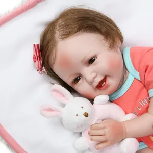 Realistic reborn baby girl doll with pink floral hairclip holding a white plush bunny