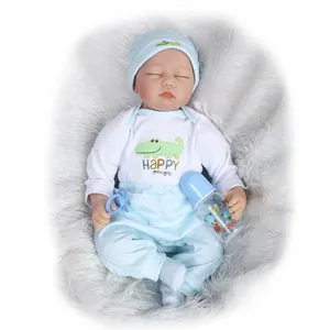 Detailed set of soft reborn baby doll with blue outfit, pacifier, and toy feeding bottle
