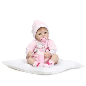 Realistic reborn baby doll in pink penguin outfit with pacifier and sippy cup