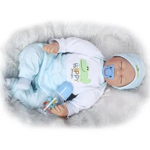 Close-up of a realistic reborn baby doll with blue striped outfit and feeding bottle