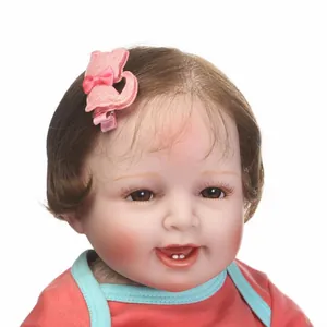Pink glitter cat hair clip with bow on soft fabric base worn by realistic baby doll