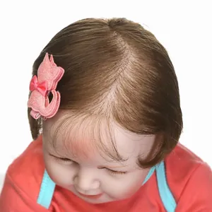 Pink glitter cat hair clip with bow on realistic baby doll hair for holiday gifts