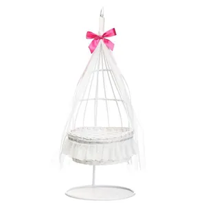 White lace wicker display basket with pink satin bow and delicate tulle accents