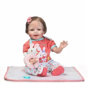 Lifelike reborn baby doll in bunny outfit with plush rattle and pacifier accessories