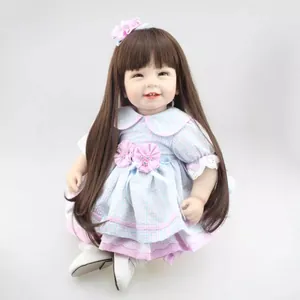 Realistic reborn baby doll with long brown hair in a blue checkered lace dress
