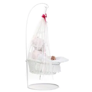 Close-up of white woven baby doll cradle with lace trim and elegant pink bow